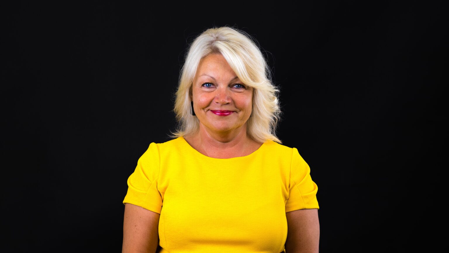 Marjeta Venno naeratamas kollase särgiga.